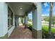 Covered porch showcasing brick pavers, sturdy columns, and meticulous landscaping at 1270 Fountain Coin Loop, Orlando, FL 32828