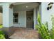 Inviting front porch with brick flooring, a charming wreath, and attractive landscaping at 1270 Fountain Coin Loop, Orlando, FL 32828