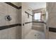 Walk-in shower featuring neutral tile, black accents and a built-in bench at 1270 Fountain Coin Loop, Orlando, FL 32828