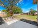 Spacious backyard featuring a patio area and beautiful shade trees at 1432 Findlay St, Deltona, FL 32725