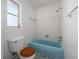 Bathroom featuring a unique blue bathtub, tiled walls, and a mosaic tiled floor at 1432 Findlay St, Deltona, FL 32725