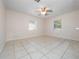 A spacious bedroom with tile flooring, dual windows for natural light, and a ceiling fan at 1432 Findlay St, Deltona, FL 32725