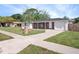 Street view of a single-story home with a brick facade, an attached garage, and a well-kept lawn at 1432 Findlay St, Deltona, FL 32725