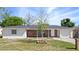 Charming single-story home featuring a brick facade, white trim, and a well-manicured lawn at 1432 Findlay St, Deltona, FL 32725