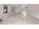 Bright living room featuring tile flooring, large windows, and access to an outdoor patio at 1432 Findlay St, Deltona, FL 32725