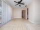 Open living area with tile flooring, ceiling fan, and view of the hallway to the kitchen at 1432 Findlay St, Deltona, FL 32725