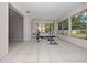 Sunroom featuring tile flooring, large windows, and natural light for a versatile living space at 1432 Findlay St, Deltona, FL 32725