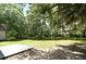 Expansive backyard offers a serene outdoor space with lush greenery and a concrete patio area at 1502 W 16 Th Street, Sanford, FL 32771