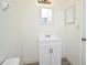 Bright bathroom featuring a white vanity, mirror, and lighting, with a view of the shower at 1502 W 16 Th Street, Sanford, FL 32771