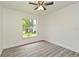 Bedroom with light gray wood flooring, ceiling fan, and a window that looks outside at 1502 W 16 Th Street, Sanford, FL 32771