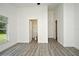 A bright bedroom features modern gray flooring, white walls and trim, and natural light from a window at 1502 W 16 Th Street, Sanford, FL 32771