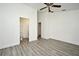 A bright bedroom features modern gray flooring, white walls and trim, and a ceiling fan at 1502 W 16 Th Street, Sanford, FL 32771