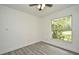 Bedroom with light gray wood flooring and a window that looks outside at 1502 W 16 Th Street, Sanford, FL 32771