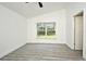 Freshly painted bedroom features gray laminate floors, crisp white walls, and a sunlit window at 1502 W 16 Th Street, Sanford, FL 32771