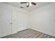 Bright bedroom with light gray wood flooring, ceiling fan, and white doors and trim at 1502 W 16 Th Street, Sanford, FL 32771