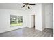 Bright bedroom with updated flooring, white walls, ceiling fan and view to the outdoors at 1502 W 16 Th Street, Sanford, FL 32771