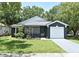 Charming single-story home with a well-manicured lawn and a one-car garage, set amidst lush green trees at 1502 W 16 Th Street, Sanford, FL 32771