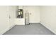Functional garage space showing the water heater, HVAC system, and a white door leading to the rest of the home at 1502 W 16 Th Street, Sanford, FL 32771