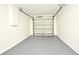 Clean, empty garage with white brick walls and a freshly painted gray floor, ready for storage or parking at 1502 W 16 Th Street, Sanford, FL 32771