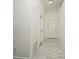 The bright hallway features white-painted walls, white doors and trim, and marble-patterned tile flooring at 1502 W 16 Th Street, Sanford, FL 32771