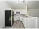 Updated kitchen with white cabinets, stainless steel appliances and gray backsplash at 1502 W 16 Th Street, Sanford, FL 32771