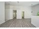 Spacious living area with multiple doorways and gray wood-look flooring at 1502 W 16 Th Street, Sanford, FL 32771