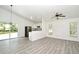 The well-lit, open-concept living room showcases a modern kitchen, large windows and a sliding door at 1502 W 16 Th Street, Sanford, FL 32771