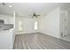 Bright living room with neutral paint, ceiling fan, and updated wood-look flooring at 1502 W 16 Th Street, Sanford, FL 32771