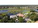 Stunning aerial view of homes by a lake, with lush greenery and beautiful landscaping in a quiet neighborhood at 1528 Langham Ter, Lake Mary, FL 32746