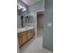 Bathroom featuring a double vanity, modern fixtures, and white wood-look flooring at 1528 Langham Ter, Lake Mary, FL 32746