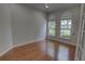 Bedroom with hardwood floors and lots of natural light from the two arched windows at 1528 Langham Ter, Lake Mary, FL 32746
