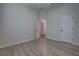 Bright bedroom with wood-look flooring, white walls, and white doors and trim at 1528 Langham Ter, Lake Mary, FL 32746
