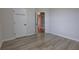 Bright bedroom with wood-look flooring and white doors to closets and other rooms at 1528 Langham Ter, Lake Mary, FL 32746