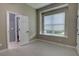 Well-lit bedroom featuring modern flooring, a large window, and a neutral paint color at 1528 Langham Ter, Lake Mary, FL 32746