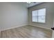 Bright bedroom with modern wood-look floors, a ceiling fan, and a window for natural light at 1528 Langham Ter, Lake Mary, FL 32746