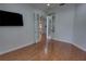 Bedroom featuring hardwood floors and view into other rooms through decorative french doors at 1528 Langham Ter, Lake Mary, FL 32746
