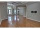 Open floor plan with detailed crown molding and hardwood floors leading to the formal dining and living spaces at 1528 Langham Ter, Lake Mary, FL 32746