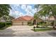 Charming single-story home features a brick driveway, tile roof and a manicured front lawn at 1528 Langham Ter, Lake Mary, FL 32746