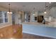 Bright kitchen featuring white cabinetry, stainless steel appliances, hardwood floors, and modern lighting at 1528 Langham Ter, Lake Mary, FL 32746