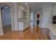 Bright kitchen featuring white cabinetry, stainless steel appliances, hardwood floors, and adjacent laundry room at 1528 Langham Ter, Lake Mary, FL 32746