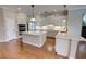 Bright kitchen featuring white cabinetry, stainless steel appliances, double islands, and hardwood floors at 1528 Langham Ter, Lake Mary, FL 32746