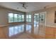Spacious living room featuring hardwood floors, neutral walls, and a view of the pool and backyard at 1528 Langham Ter, Lake Mary, FL 32746