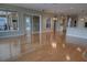 Bright, open living space with wood floors, sliding glass doors, and view into the kitchen at 1528 Langham Ter, Lake Mary, FL 32746