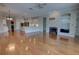 Bright living room featuring hardwood floors, fireplace, built-in shelving, open floor plan and kitchen with stainless appliances at 1528 Langham Ter, Lake Mary, FL 32746