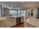 Bright living room featuring kitchen, windows to the backyard pool, and stainless appliances at 1528 Langham Ter, Lake Mary, FL 32746