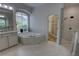 Main bathroom featuring soaking tub, separate shower, and walk-in closet at 1528 Langham Ter, Lake Mary, FL 32746