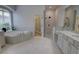 Spa-like main bathroom with tiled floors, soaking tub, granite countertops and walk-in shower at 1528 Langham Ter, Lake Mary, FL 32746