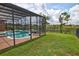 Private screened pool with a tranquil pond view, surrounded by lush landscaping and a spacious yard at 1528 Langham Ter, Lake Mary, FL 32746