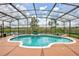Beautiful kidney-shaped pool with screened enclosure and views of the community lake at 1528 Langham Ter, Lake Mary, FL 32746