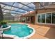 Sparkling screened-in pool with a curved design, complemented by an expansive outdoor patio at 1528 Langham Ter, Lake Mary, FL 32746